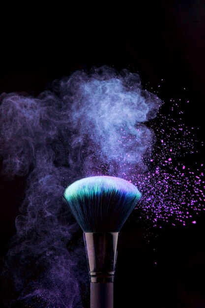 Makeup brush with blue powder splash