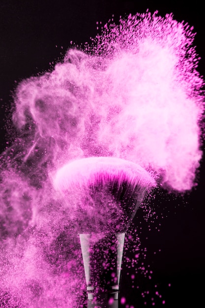 Makeup brush with neon pink powder splash