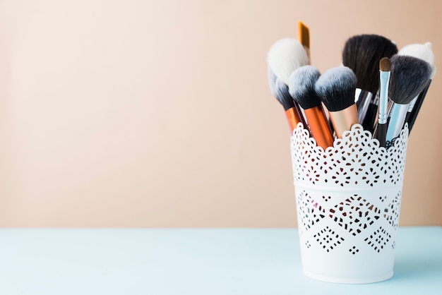 Makeup brushes in lacy cup