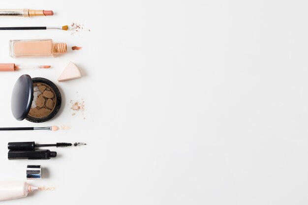 Makeup products arranged on gray background