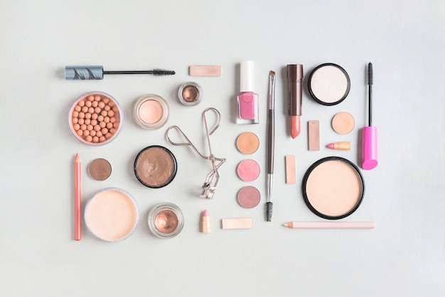 Free photo makeup products arranged in rectangular shape on white backdrop