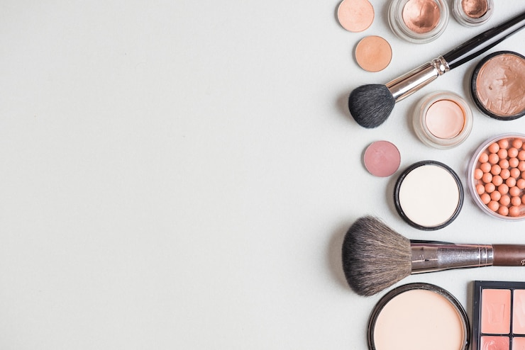 Free Photo makeup products and brushes on white backdrop