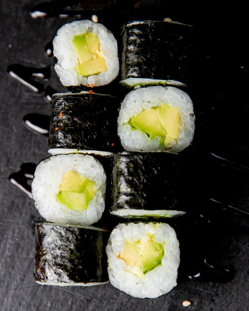 maki roll with avocado served with sauce