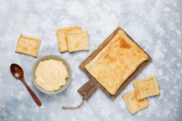 Making fresh delicious puff pastry with heavy cream on concrete ,top view