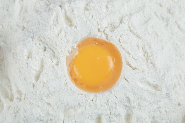 Making pie with ingredients as egg yolk and flour