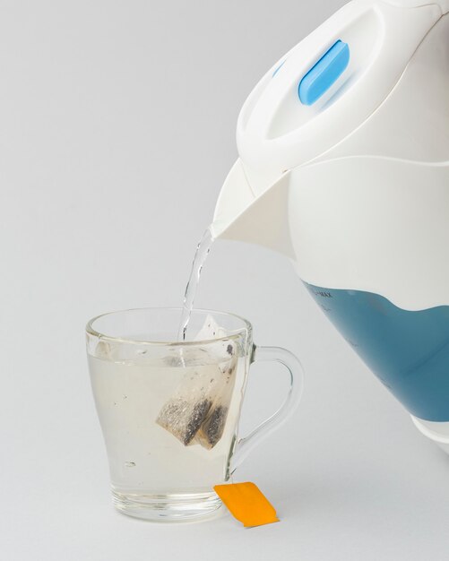 Making a tea with hot water from electric kettle