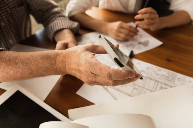 Male architect presents project of future house for young family