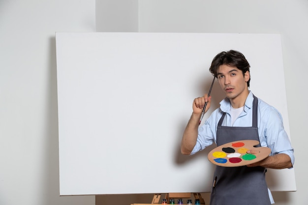 Male artist starting his new painting and thinking about something white background drawing art