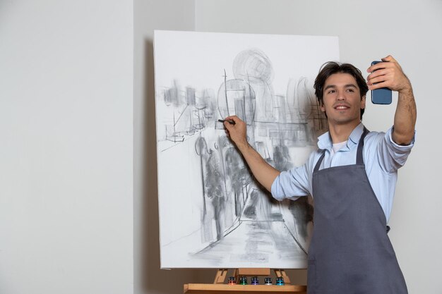 彼の黒と白の絵画、白い背景の描画アートで自分撮りを撮る男性アーティスト