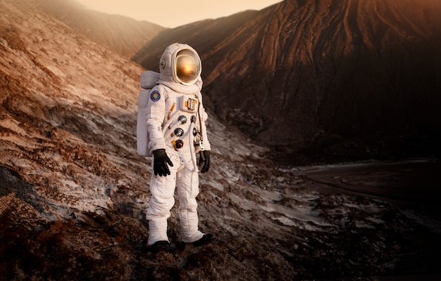 Male astronaut exploring the surroundings during a space mission on another planet
