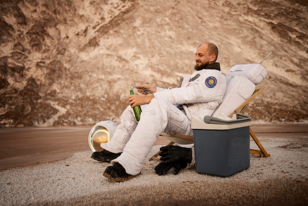 Male astronaut opening a beer during a space mission on an unknown planet