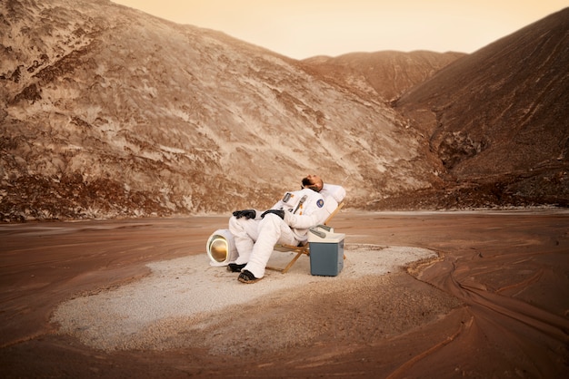 Male astronaut relaxing on an unknown planet