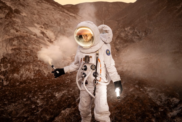 Free photo male astronaut signaling his location during a space mission on an unknown planet