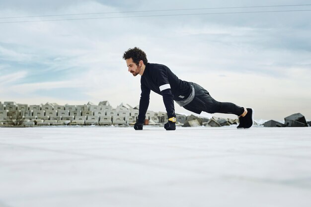 Male athlete doing push-ups outside