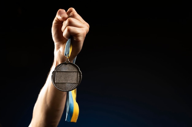 Male athlete holding a medal