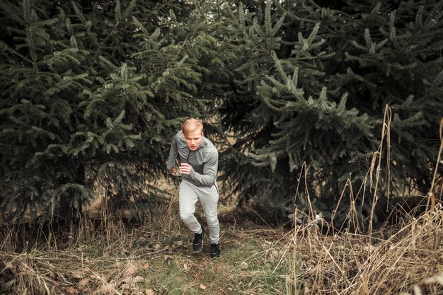 Male athlete running in forest