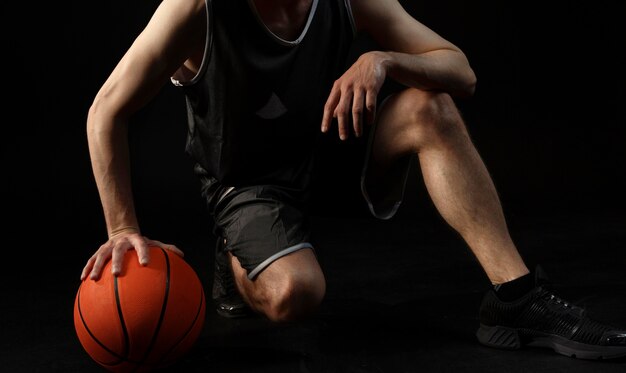 Male athlete with basketball posing
