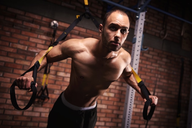 Male athlete working out with resistance bands