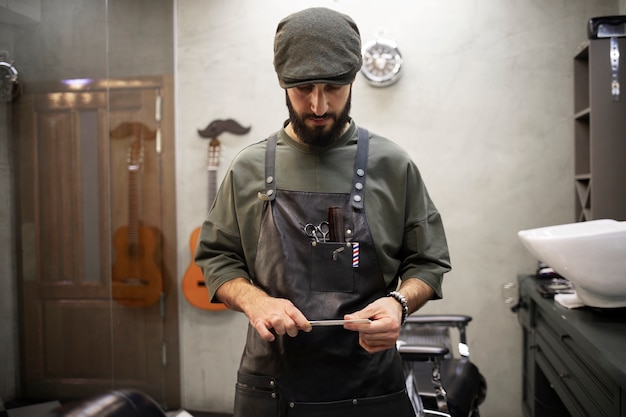 Male barber sitting at his shop