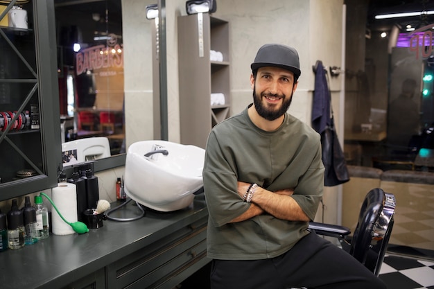 Male barber sitting at his shop