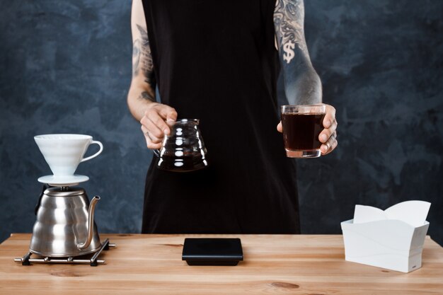 Male barista brewing coffee. Alternative method pour over.