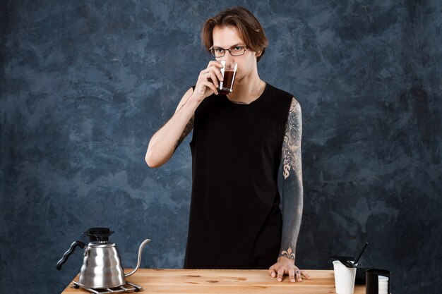 Male barista taste coffee. Alternative methods of brewing.