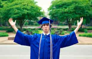 Free photo male in a blue mantle enjoying the freedom after graduation