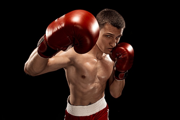 Male boxer boxing on black