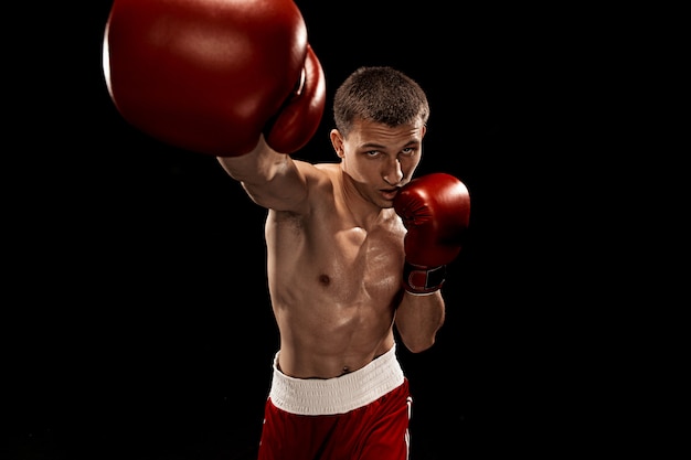 Male boxer boxing with dramatic edgy lighting on black