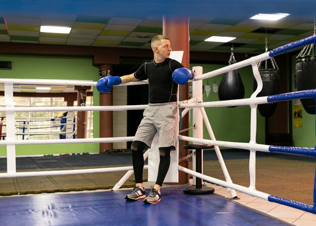 Male boxer with gloves in the ring