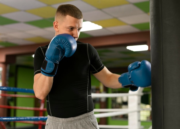 Male boxer with gloves training