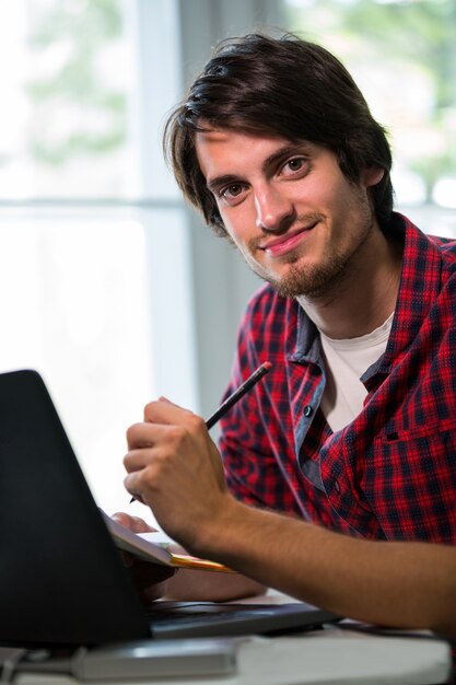 Male business executive writing on notepad