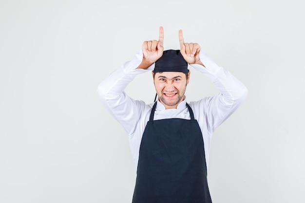 Free Photo Male Chef In White Uniform Showing Silence Gesture And Looking Careful Front View 