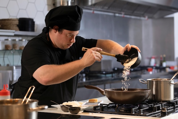 Male chef in kitchen cooking