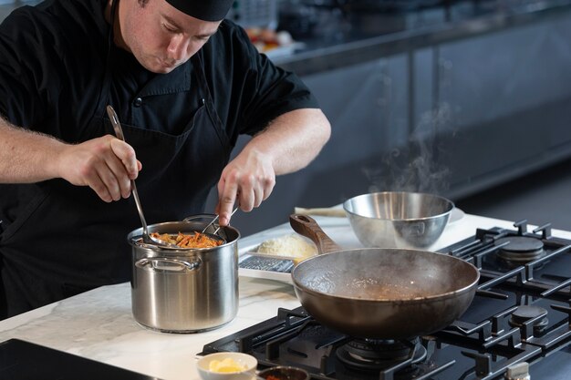 Male chef in kitchen cooking