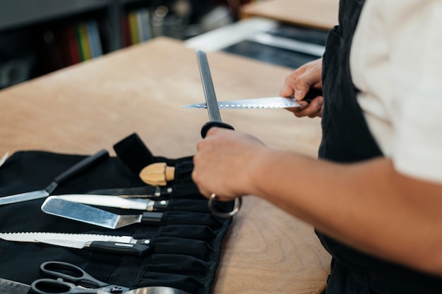 Male chef sharpening his knives