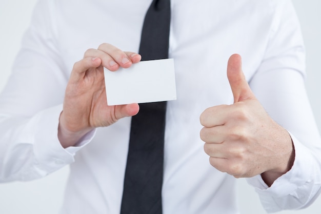 Male consultant showing business card and thumb-up