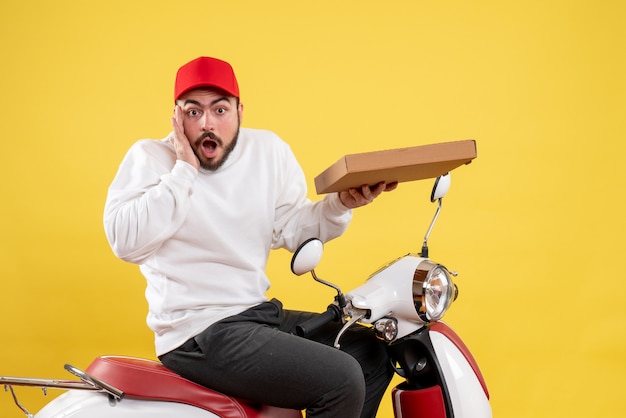 male courier holding delivery food on yellow