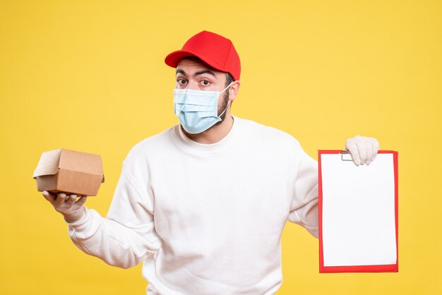 male courier in mask holding file note and little food package on yellow