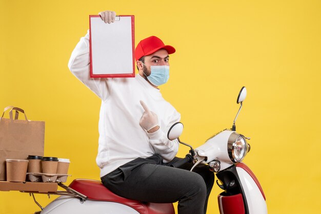 male courier in mask holding file note on yellow