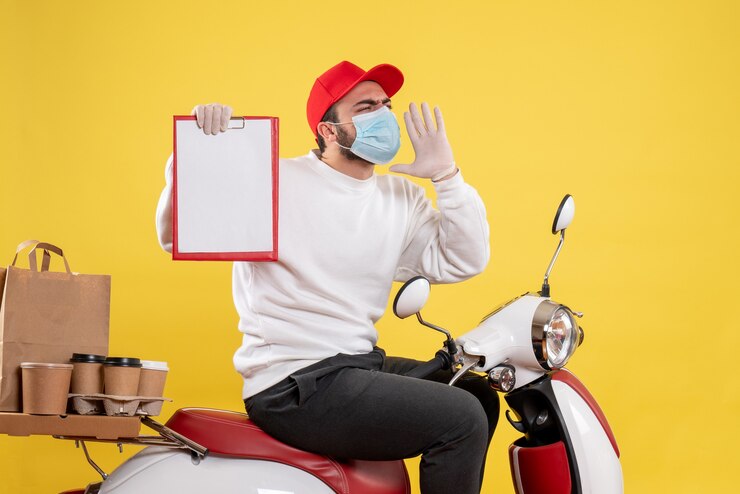 Free Photo male courier in mask holding file note on yellow