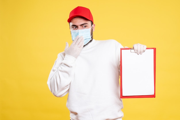 male courier in mask holding file note on yellow