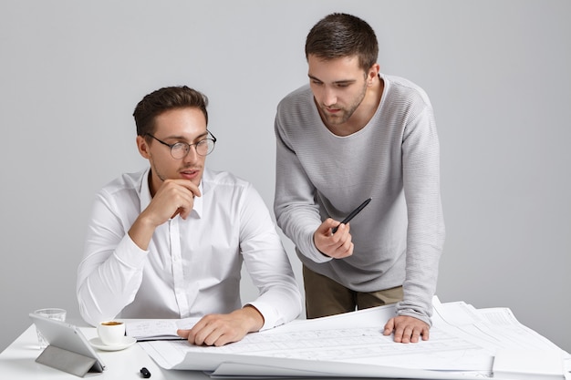 Male coworkers doing paperwork