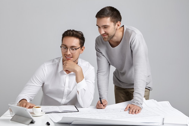 Male coworkers doing paperwork