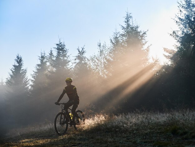 Male cyclist riding bicycle in the morning