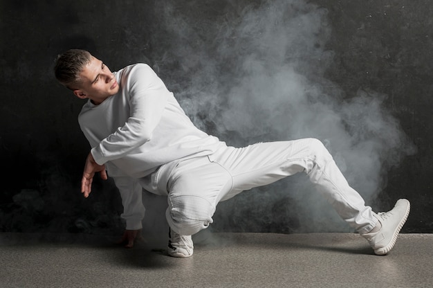 Male dancer posing with fog