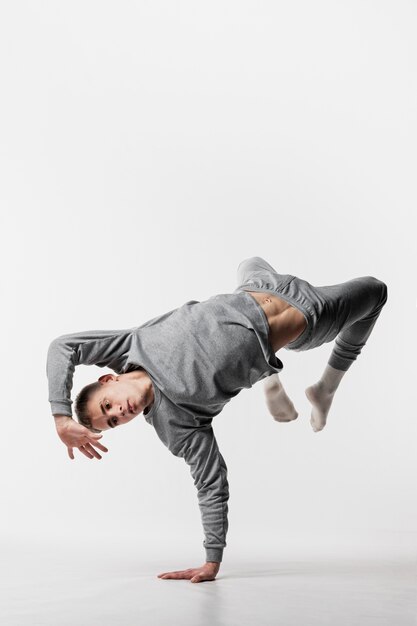 Male dancer in tracksuit dancing with copy space
