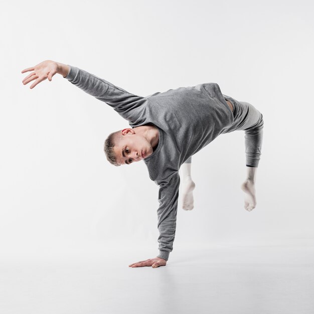 Male dancer in tracksuit and socks busting a move