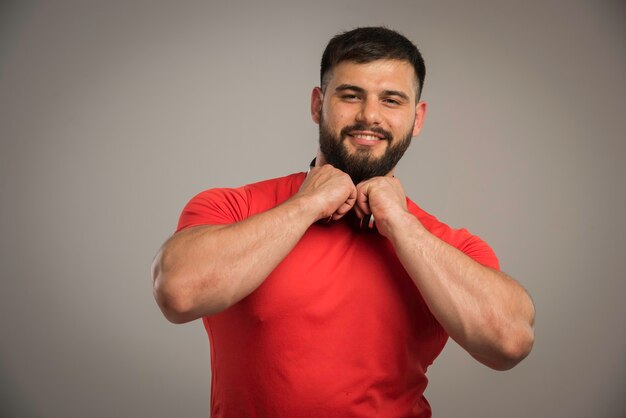 Male dj in red shirt with headphones in the neck having fun