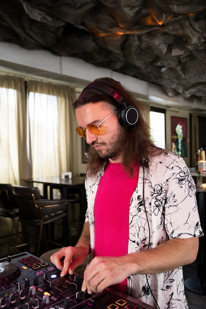 Male dj taking care of the music entertainment at a party